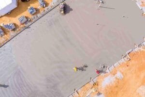 Newly poured concrete driveway surface compared to asphalt for residential homes in Rockwall, TX