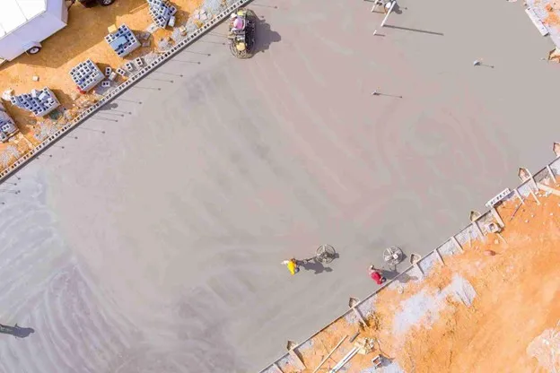 Newly poured concrete driveway surface compared to asphalt for residential homes in Rockwall, TX